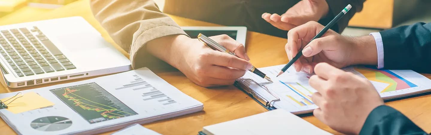 People working over charts and graphs regarding business