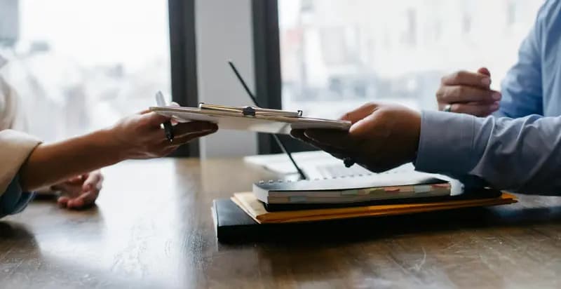 Two people looking at a resume