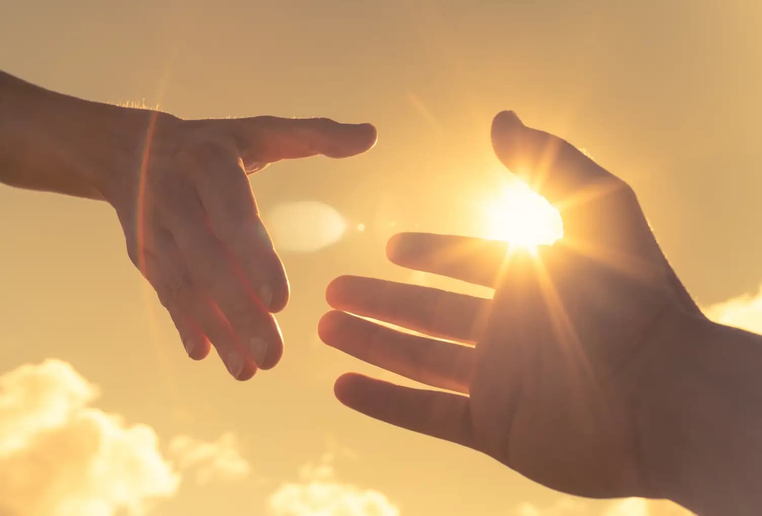 Two people reaching their hands out to each other.