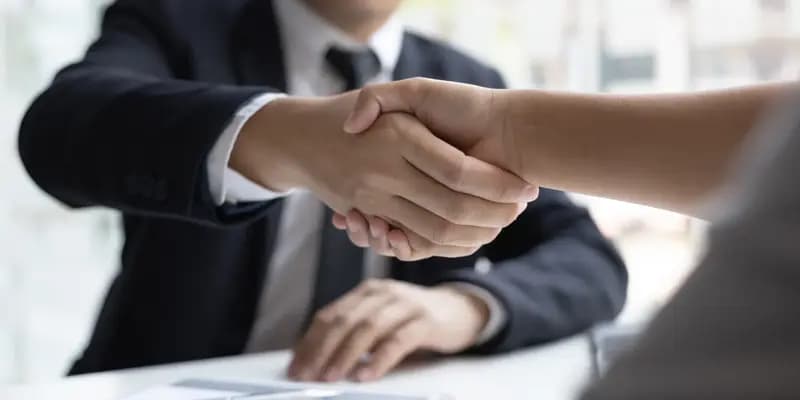 Two people handshaking at a business meeting/interview